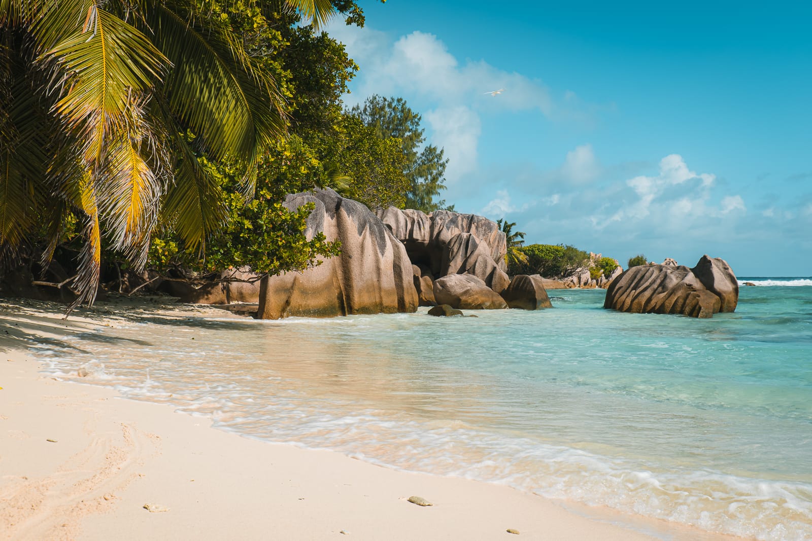 White sand beach with clear blue water on La Digue, Seychelles