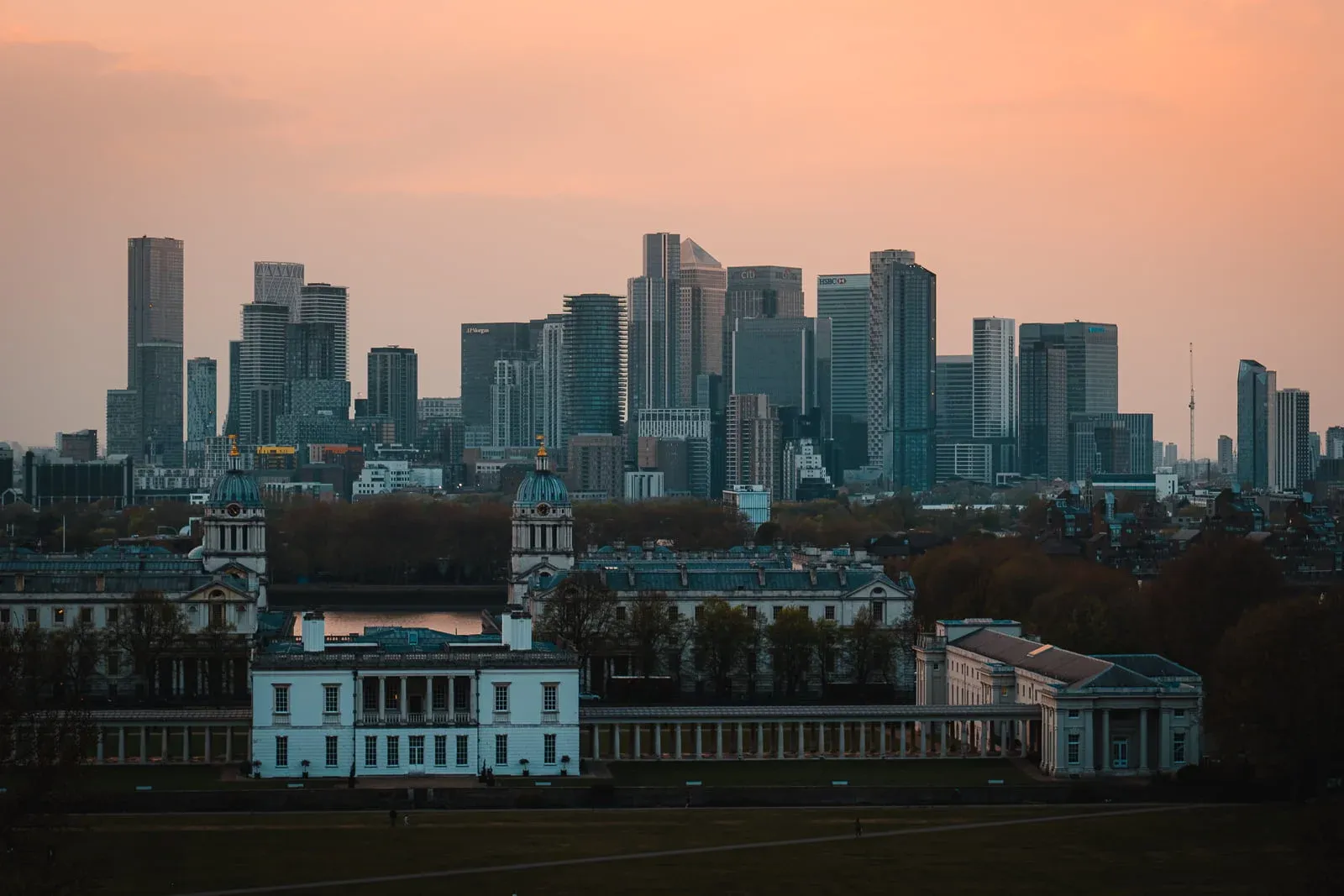 London skyline with an orange sunset from Greenwich Park