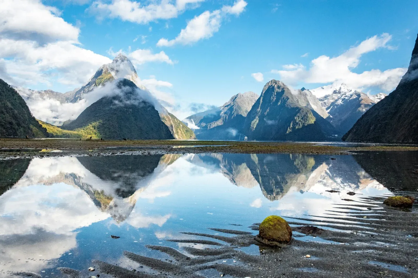 Panoramic view of mountains reflected in Milford Sound, New Zealand