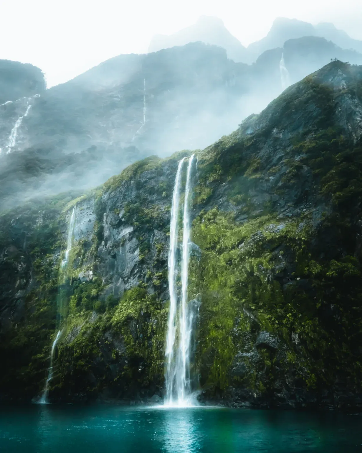 Waterfall in the mist at Milford Sound, New Zealand