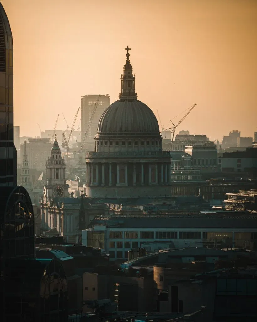 View of St Pauls with orange sunset from The Garden at 120 rooftop in London