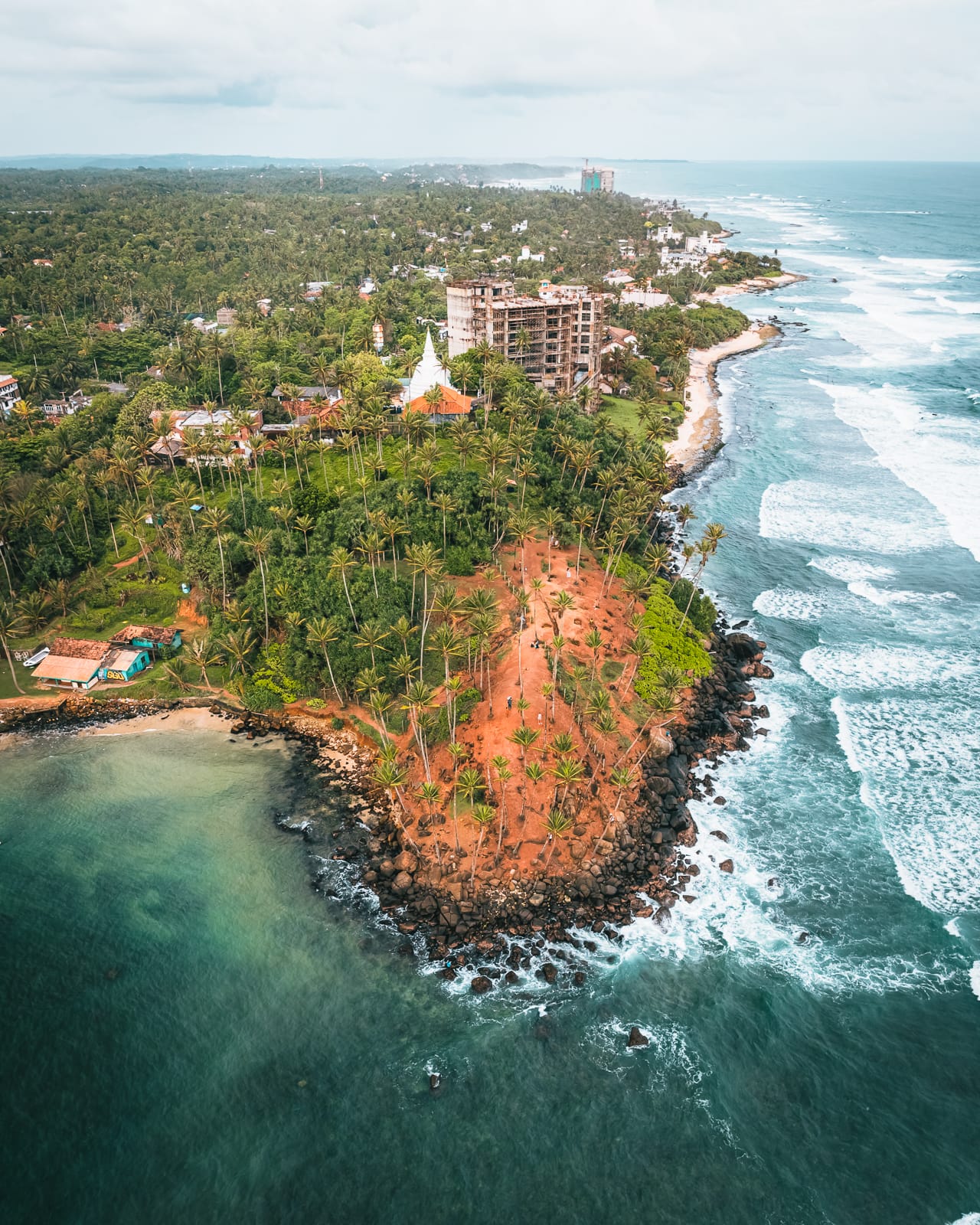 Aerial drone view of Palm trees and ocean at coconut tree hill in Mirissa, Sri Lanka