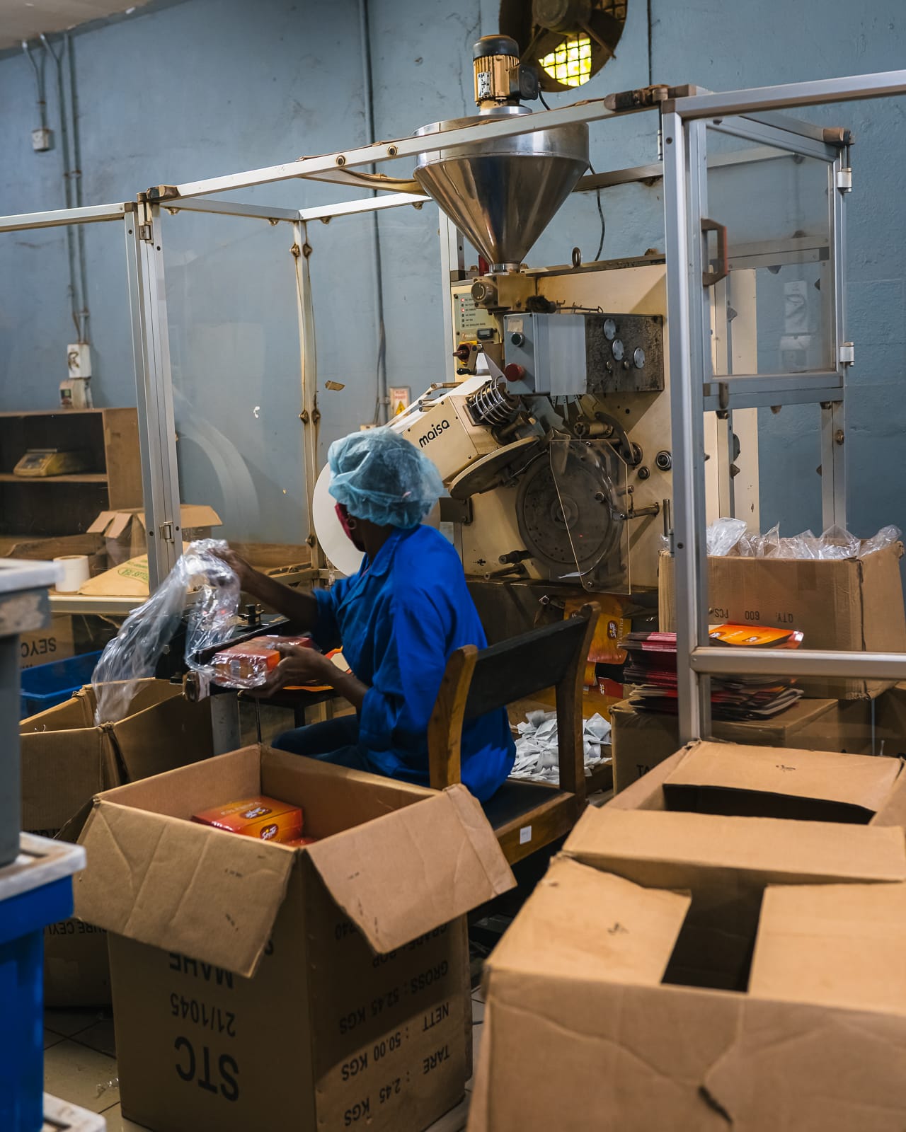 Woman packing tea in a tea factory in the seychelles