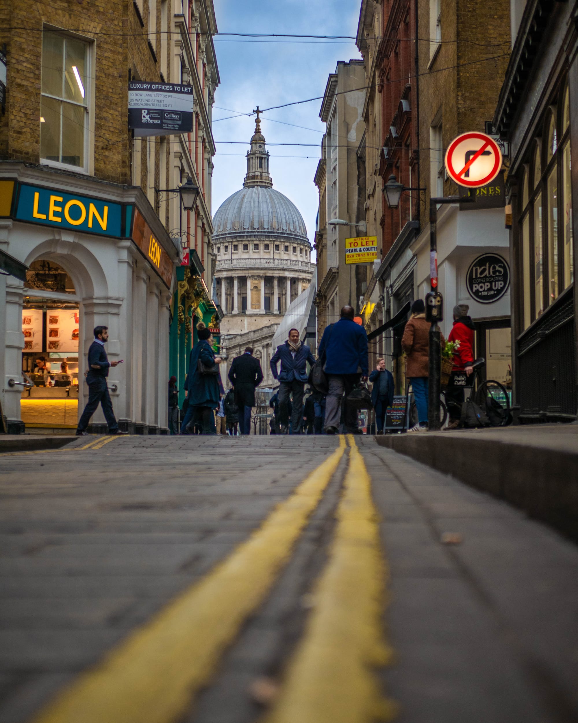 View of St Paul's Cathedral at the end of a pedetrian street.