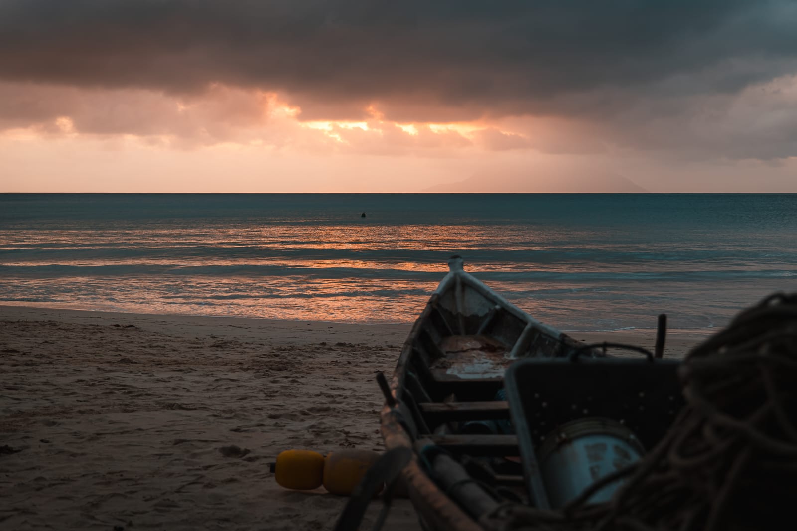 boat on a sandy beach at sunset