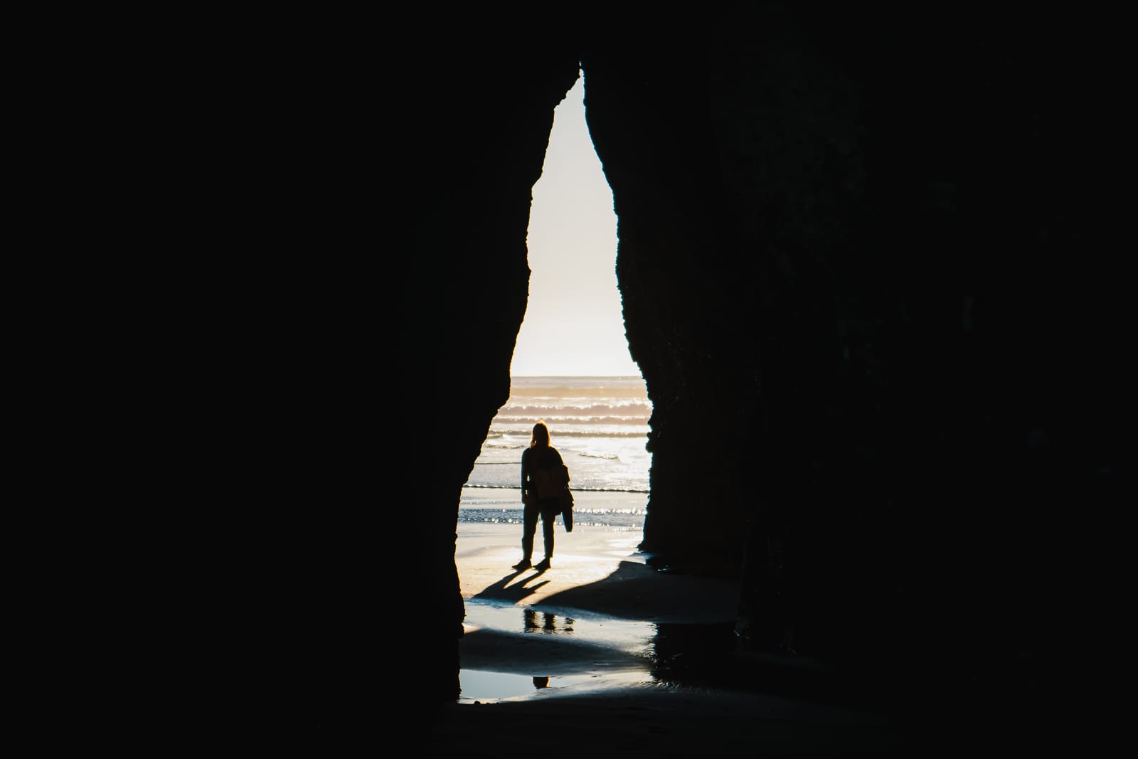 woman standing in cave at wharariki beach