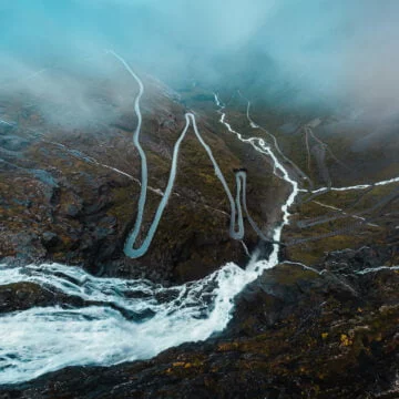 Cloudy aerial view of waterfall flowing through the Trollstigen road in Norway