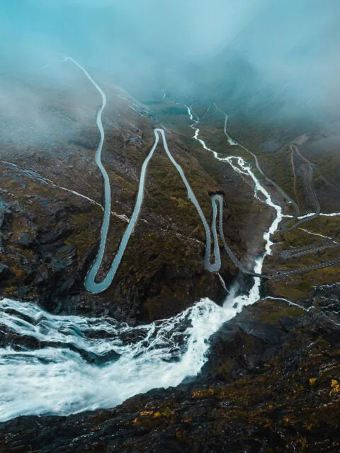 Cloudy aerial view of waterfall flowing through the Trollstigen road in Norway