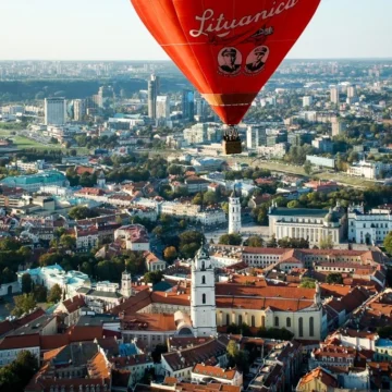 Hot air balloon flying over Vilnius old town skyline, Lithuania