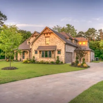 modern brick house with a driveway and garden